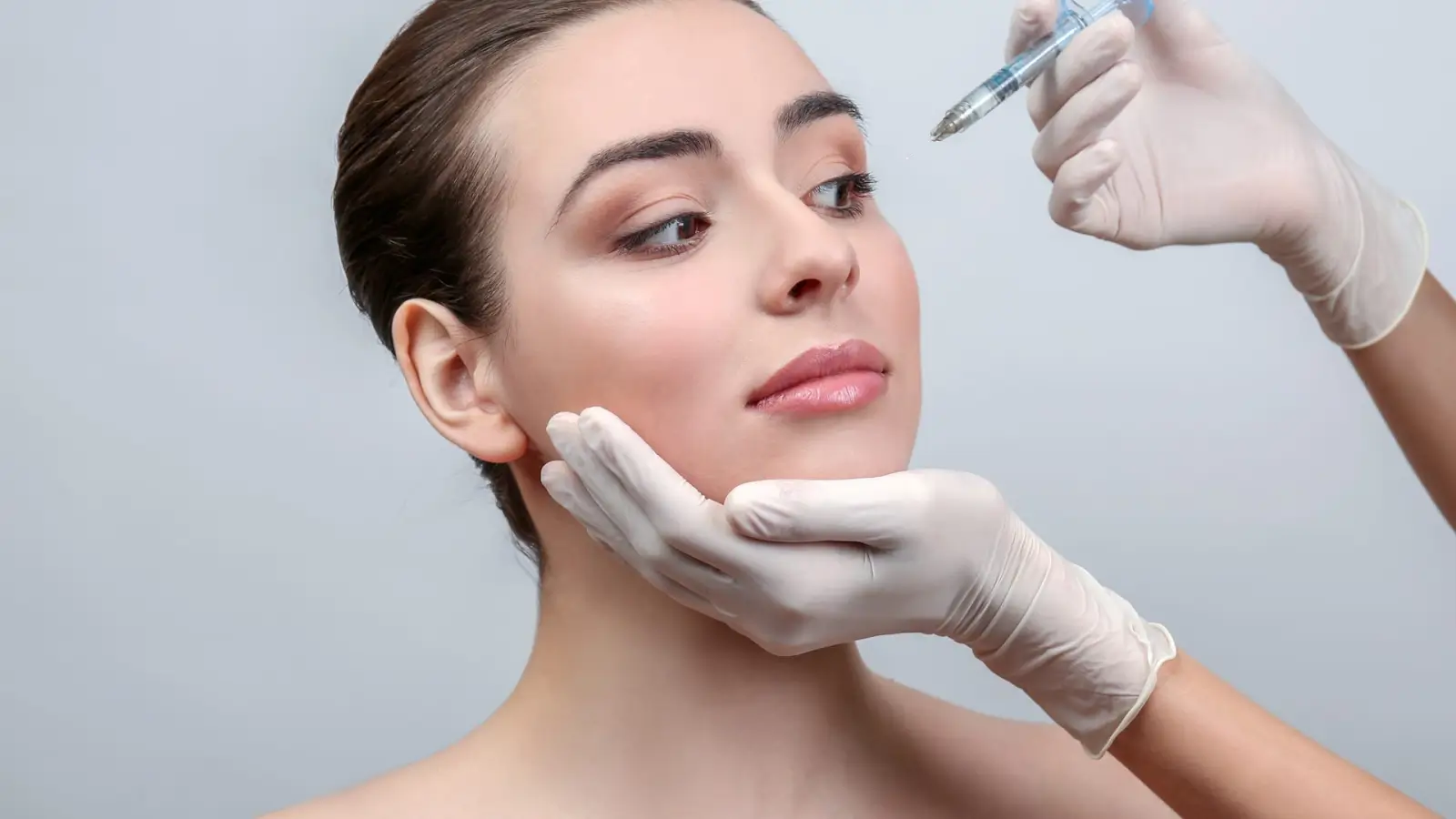 Woman getting a facial injection. 