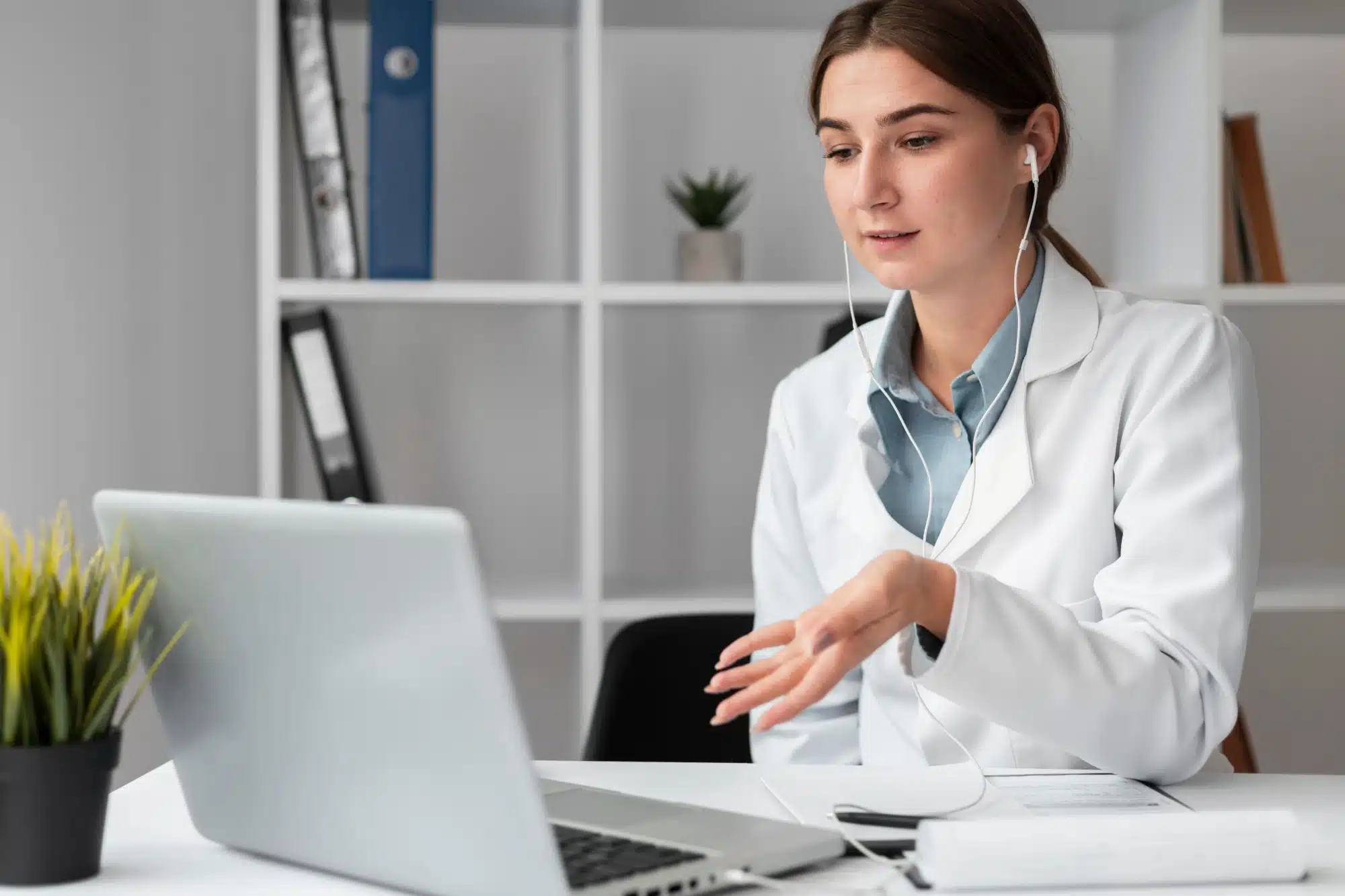 Young doctor having an online consultation on her laptop