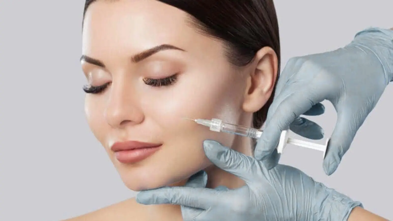 Woman getting a facial injection. 