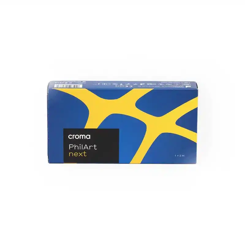 A blue and yellow box labeled "CROMA PhilArt NEXT" with abstract yellow lines on a blue background. The packaging appears to be for a product, possibly in the electronics or accessories category. The box has a sleek and modern design.