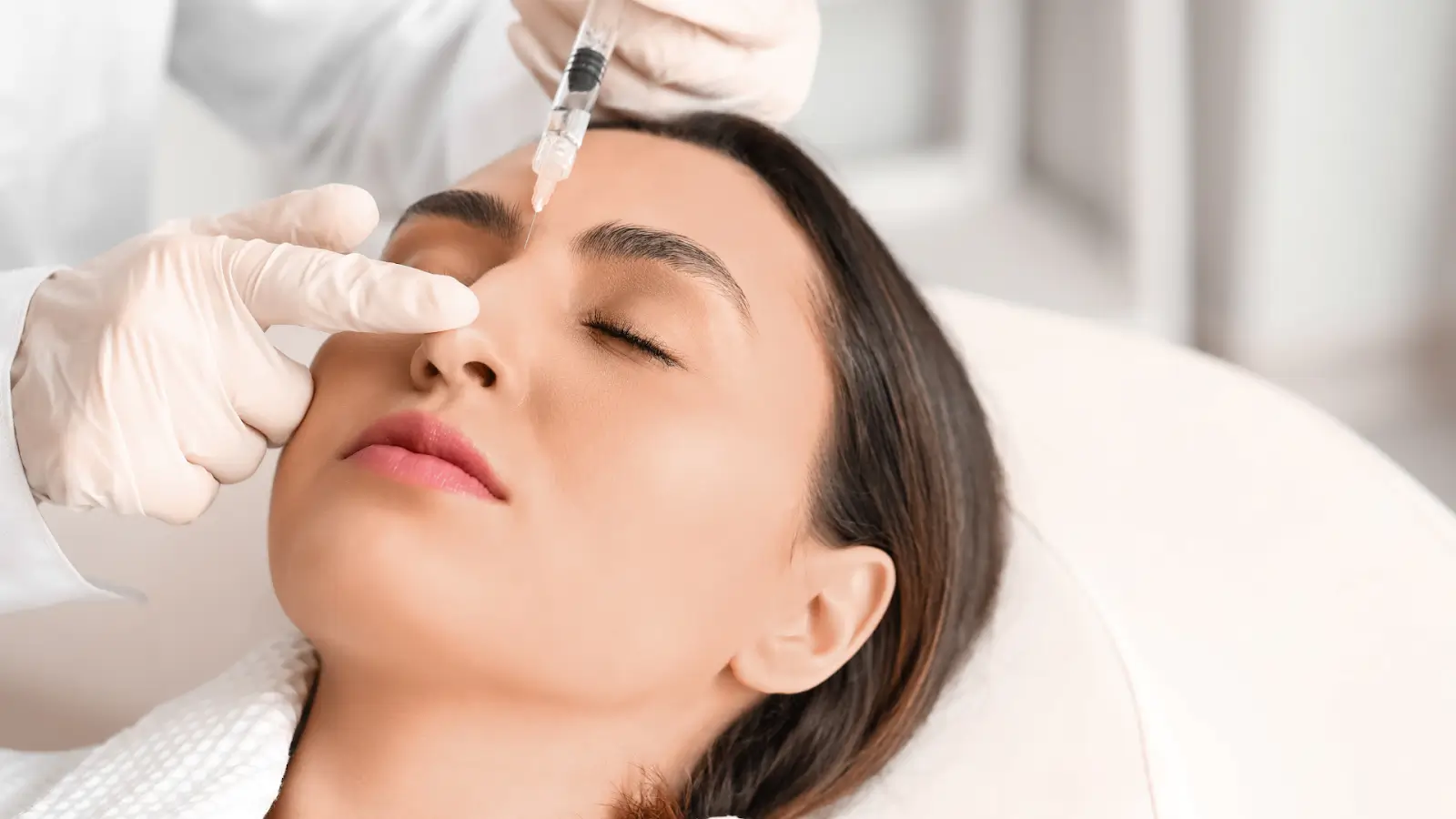 Woman getting her nose injected.