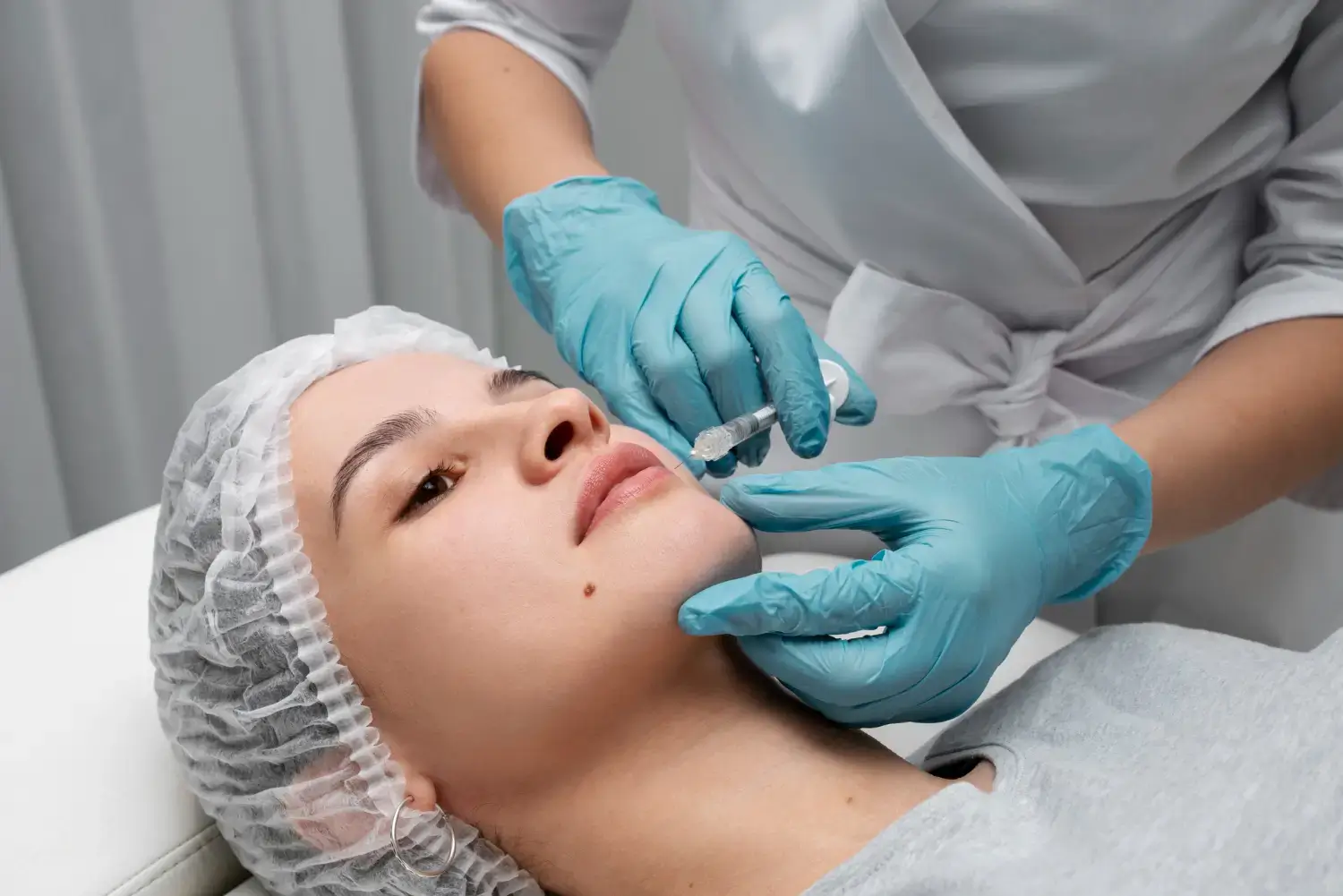 A person lying down receives a Neuramis filler injection from a medical professional.